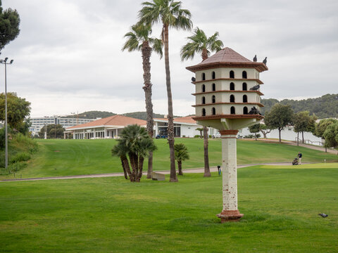Large wooden dovecote tower on a lush green golf course
