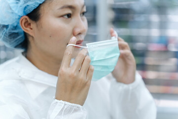 Nurse Hooking Surgical Mask Ear Loop – Profile View Hantavirus PPE Step © อภิสิทธิ์ ปักเหนือ