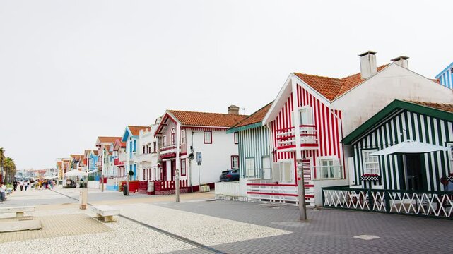 A slow panning shot showing the famous traditional colorful striped houses on the coast of Costa Nova in Portugal. 24.05.2026
