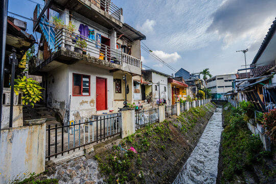 Residential buildings along a concrete canal in Kota Malang