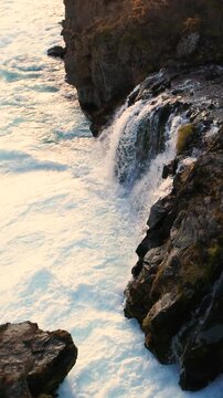 Epic Waterfall in scenic iceland nature, aerial shot - vertical video