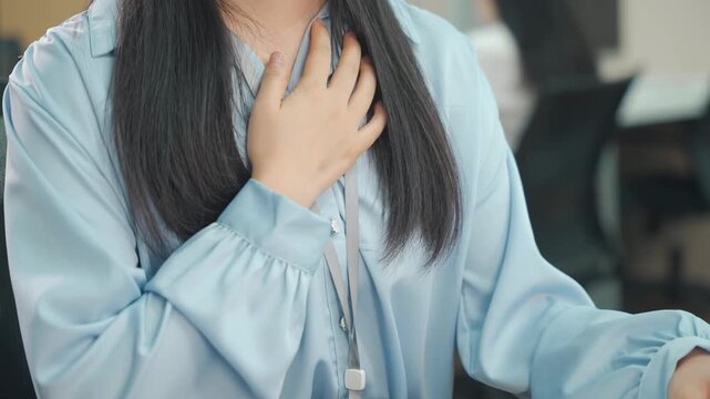 Office worker woman hands massage chest pain sudden difficulty breathing possibly due to heart problems, panic attack, anxiety, asthma, cardiac arrest, stress or stroke, breathing issue in health risk