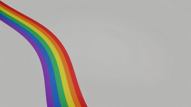 Minimalist Rainbow Ribbon on Gray Background with Copy Space for Pride Month Marketing Banner