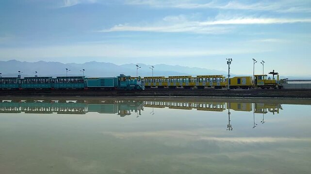Chaka Qinghai China July 13 2025. passenger trains crossing at Chaka Salt Lake Railway Station as travelers board and disembark at the famous Chaka Salt Lake in Qinghai, China, showcasing railway tran