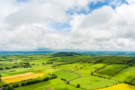 Patchwork fields spread across County Meath, Ireland, under heavy cloud. A peaceful Boyne Valley farming landscape of hedgerows, pasture and rural roads.