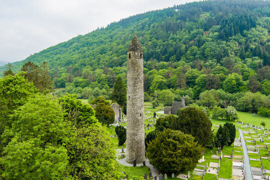 Aerial view of ancient cemetery and round tower at Glendalough Monastic Site in County Wicklow, Ireland. Historic Irish landmark in Wicklow Mountains National Park