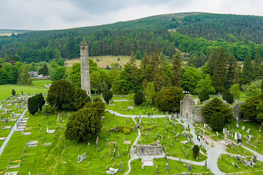 Aerial view of ancient cemetery and round tower at Glendalough Monastic Site in County Wicklow, Ireland. Historic Irish landmark in Wicklow Mountains National Park