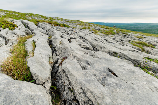 Limestone pavement landscape in Burren National Park, County Clare, Ireland. Wild karst scenery on the Wild Atlantic Way with views across the Irish countryside.