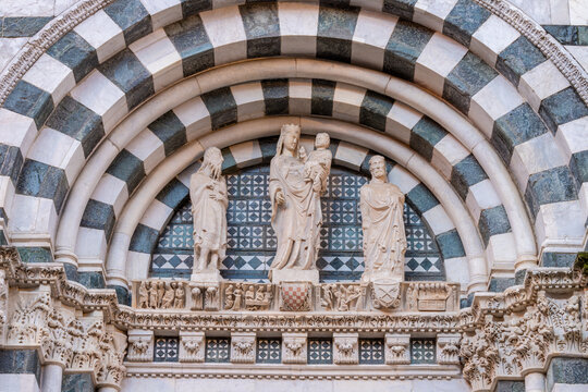 Pistoia - The detail of medieval side portal of Baptistery of San Zeno cathedral with the Madonna, St. John the Baptist and S. Peter by Tommaso Pisanovi aand Nino Pisano (1330 - 1350)
