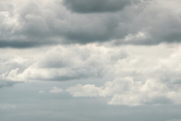 Fototapeta premium Dramatic storm clouds for the background. Isolated summer storm clouds before a thunderstorm. Dark storm clouds before the rain. Bad weather. A heavenly landscape of clouds in the sky on a rainy day.