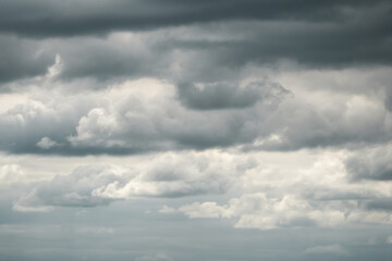 Obraz premium Dramatic storm clouds for the background. Isolated summer storm clouds before a thunderstorm. Dark storm clouds before the rain. Bad weather. A heavenly landscape of clouds in the sky on a rainy day.