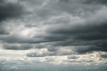 Fototapeta premium Dramatic storm clouds for the background. Isolated summer storm clouds before a thunderstorm. Dark storm clouds before the rain. Bad weather. A heavenly landscape of clouds in the sky on a rainy day.