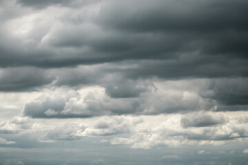 Obraz premium Dramatic storm clouds for the background. Isolated summer storm clouds before a thunderstorm. Dark storm clouds before the rain. Bad weather. A heavenly landscape of clouds in the sky on a rainy day.