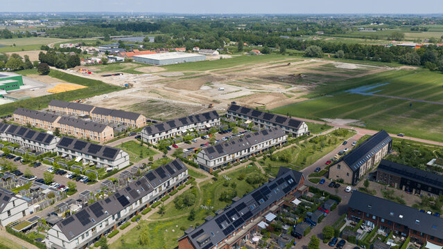 Aerial view of Ecodorp Zuiderveld featuring modern sustainable housing with solar panels on rooftops and green gardens in Nijmegen, Gelderland, Netherlands.