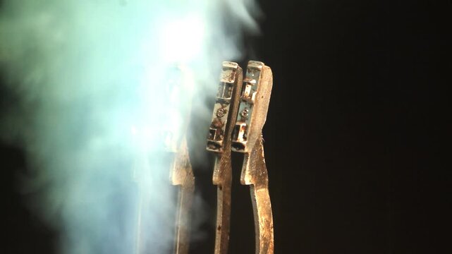 The word EVIL with a vintage typewriter hammers with green smoke 