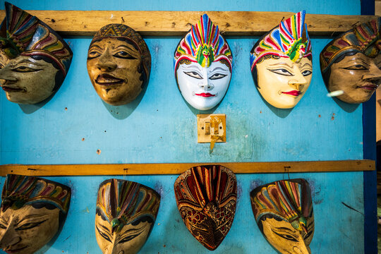 Traditional Indonesian masks on a blue wall in Yogyakarta
