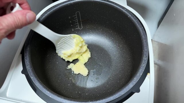 Melting of solid animal fat in household multi-cooker pot