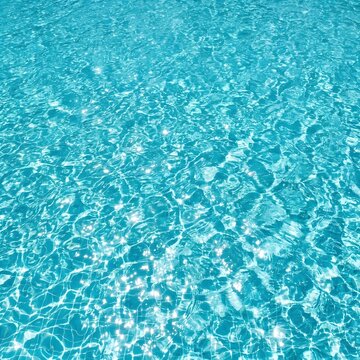 Crystal clear turquoise swimming pool water texture seen from above
