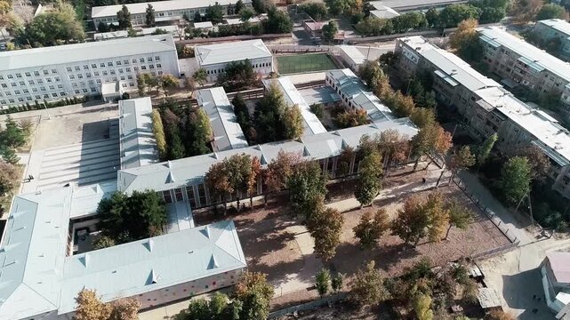 Tashkent, Uzbekistan - 06 06 2025: Aerial View of School Building with Courtyard and Red Roof