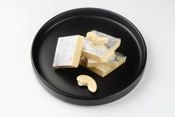 Indian most popular sweets called Kaju Katli isolated on white background  © Chandrakant