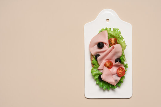 Sandwich with mortadella sausage lettuce tomatoes and olives, fresh deli lunch and Mediterranean cuisine concept