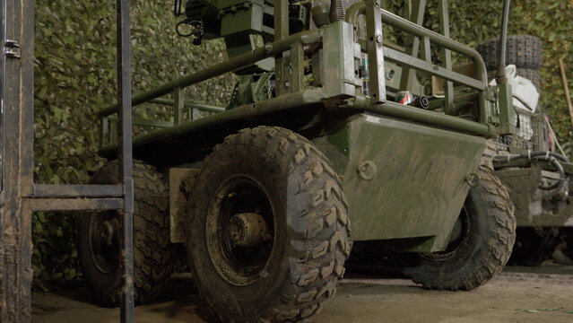 A detailed capture of a military ground drone system equipped for modern warfare. The image showcases the tactical hardware used in current military operations, emphasizing technological superiority a