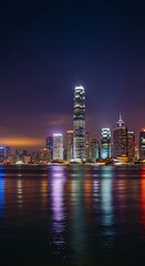 Obraz premium Illuminated Modern Skyscraper Skyline Reflecting on Harbor Water at Night