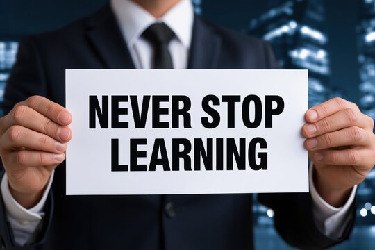 Businessman holding a white paper sign with never stop learning concept