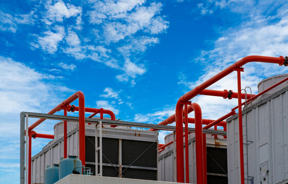 Cooling tower on roof top of building. Industrial air cooling system. Air chiller. Unit of air conditioner. Air cooled chiller with piping system on rooftop of building. Cooling tower outside building