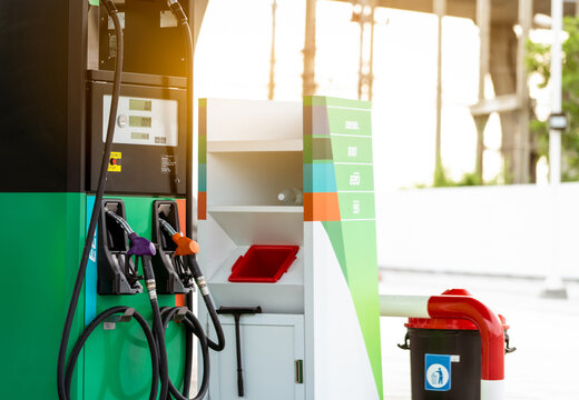 Petrol pump filling fuel nozzle in gas station. Fuel dispenser machine. Refuel fill up with petrol gasoline. Petrol industry and service. Petrol price and oil crisis concept. Petroleum oil industry.