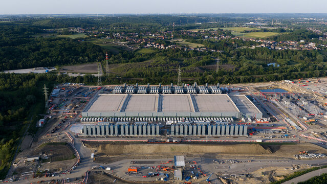 Aerial view of the Charleroi SAM 3A power plant with cooling units and electrical infrastructure surrounded by lush greenery Farciennes, Region wallonne, Belgium.