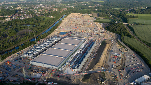 Aerial view of the Charleroi SAM 3A industrial construction site with massive rectangular buildings and earthworks in Farciennes, Region wallonne, Belgium.