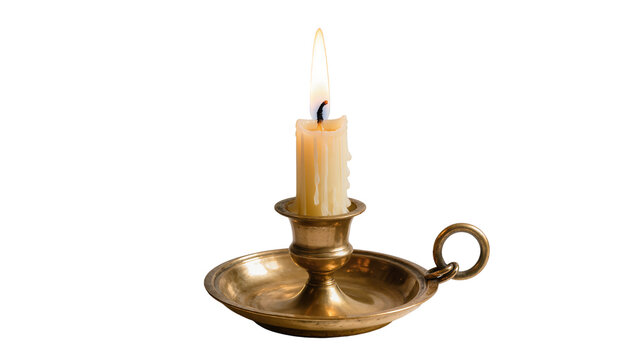 Burning candle in antique brass candlestick with drip marks