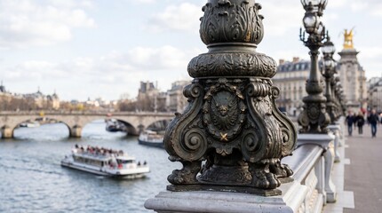 Obraz premium Ornate bridge lamp detail overlooking a Parisian river with boats and architecture