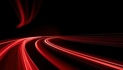 Fototapeta premium Red light trails streak across a black background, suggesting rapid motion