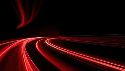 Red light trails streak across a black background, suggesting rapid motion © Syawal