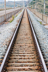 Fototapeta premium A long railway track stretches towards the horizon under a winter sky