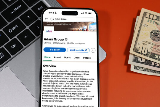 Kiel, Germany - 05-20-2026: Adani Group Indian multinational conglomerate company focused on energy, resources, logistics, and infrastructure Profile on LinkedIn displayed in a workspace enviroment