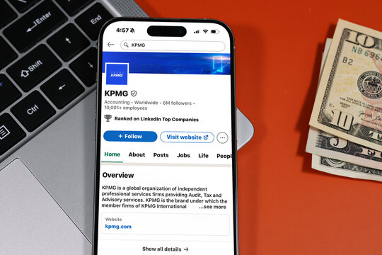 Kiel, Germany - 05-20-2026: KPMG Global professional services and audit firm Profile on LinkedIn displayed in a workspace enviroment with laptop