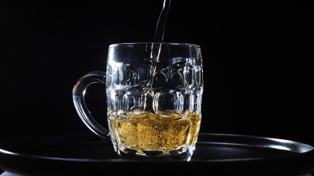  Beer in a glass. The drink is poured into the glass.