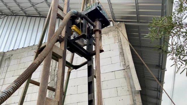 Portable water well drilling rig machine operating at a construction site