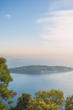 Island floats beneath blue horizon