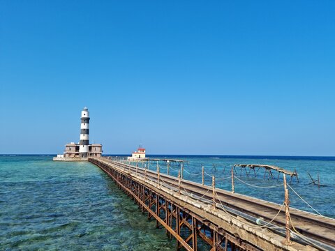 Lighthouse on a small island in the middle of the sea