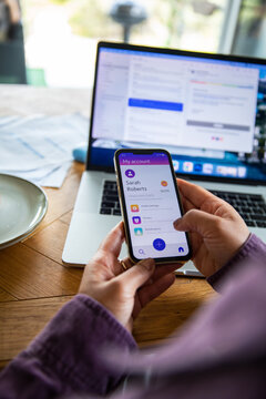 Person using mobile banking app at home office