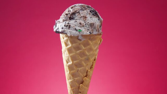 Ice cream in a waffle cone rotates around its axis