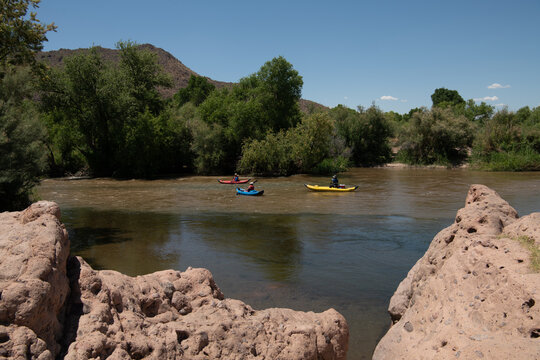 Paddlers at the confluence of the Verde River (muddy) and the Salt River (clear), near Phoenix, Arizona