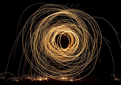 Circular light painting with sparks, slow shutter speed, abstract pattern, isolated on transparent background, dark, glowing, energetic, creative