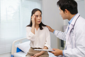 Fototapeta premium Doctor offering comfort and support to a female patient feeling unwell, experiencing pain or stress during a healthcare visit