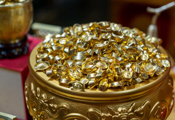 Pile of Traditional Chinese Gold Ingots in Gilded Carved Jar © onlyyouqj