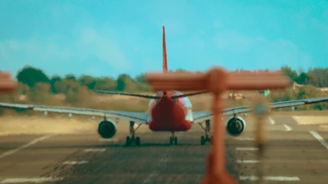 Airliner taking off with strong crosswind causing drift on runway. Jet accelerating and lifting off during dangerous side wind conditions with visible runway deviation. Aircraft departing in turbulent